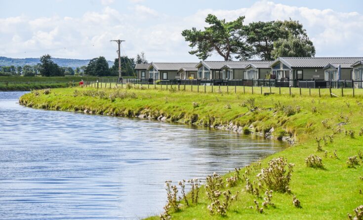 pure leisure parks - riverside picture with holiday homes alongside
